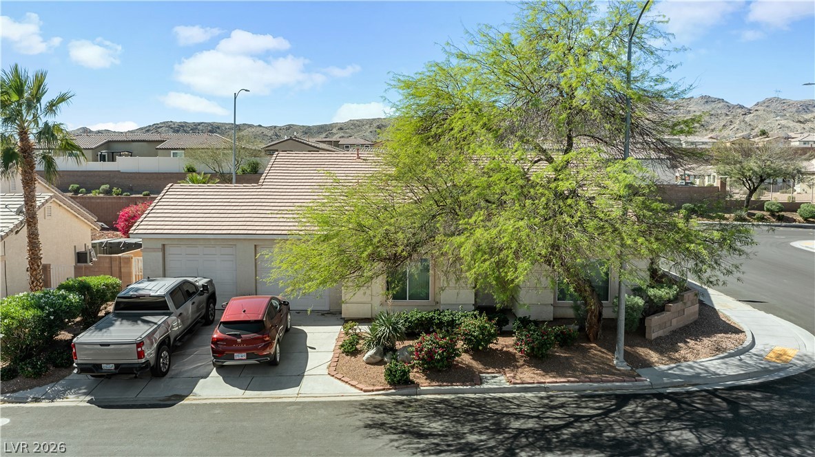 2823 Rippling Springs Street Laughlin, NV 89029 - Photo 76 of 89 View of front facade with an attached garage, a mountain view, driveway, and a residential view