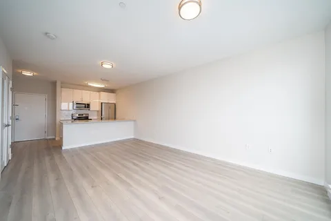 a view of kitchen with refrigerator and window