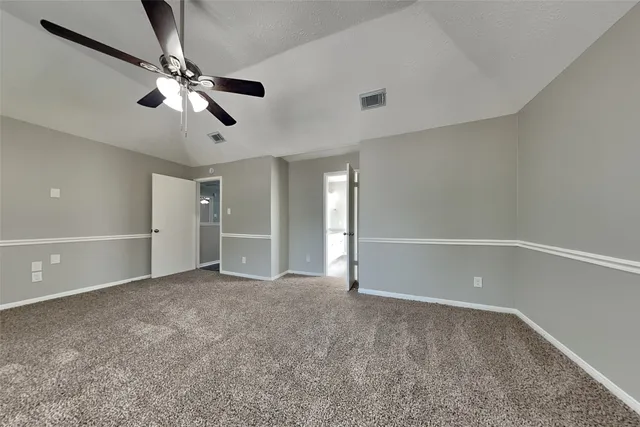 a view of an empty room with a fan