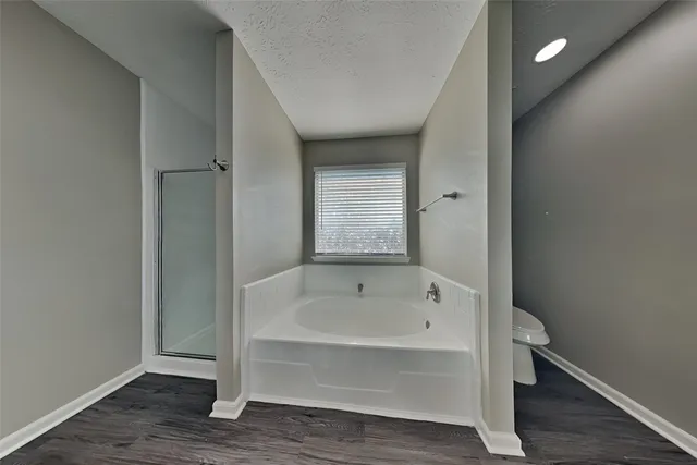 a bathroom with a bathtub and shower