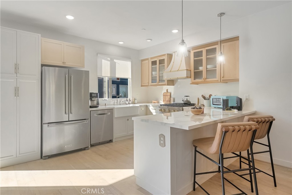 2581 Arvia Street, Unit 3 Los Angeles, CA 90065 - Photo 10 of 52 a kitchen with refrigerator cabinets and a sink
