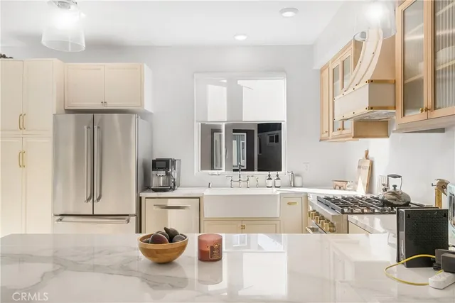 a kitchen with refrigerator cabinets and a sink