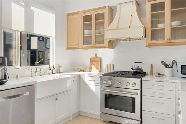 a living room with stainless steel appliances kitchen island granite countertop a sink and cabinets