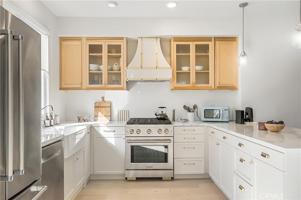 2581 Arvia Street, Unit 3 Los Angeles, CA 90065 - Photo 13 of 52 a kitchen with stainless steel appliances granite countertop white cabinets and a stove top oven