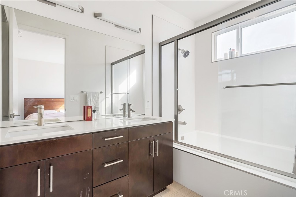 2581 Arvia Street, Unit 3 Los Angeles, CA 90065 - Photo 18 of 52 a bathroom with a granite countertop sink a mirror a vanity and a shower