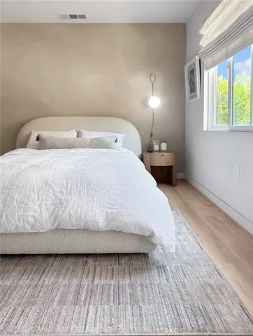 a bed room with a bed and a window