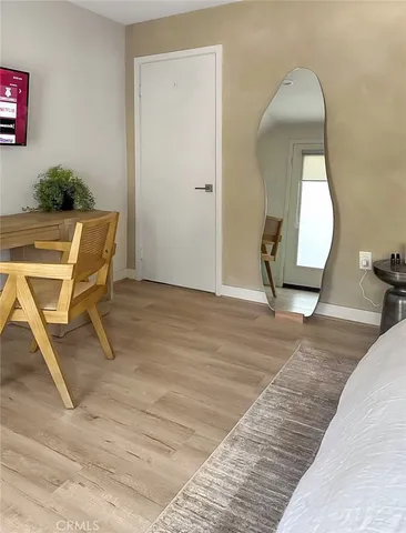 a large bed sitting in a bedroom next to a window