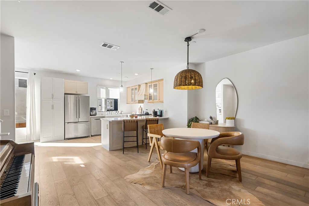 2581 Arvia Street, Unit 3 Los Angeles, CA 90065 - Photo 3 of 52 a kitchen with a dining table chairs and cabinets