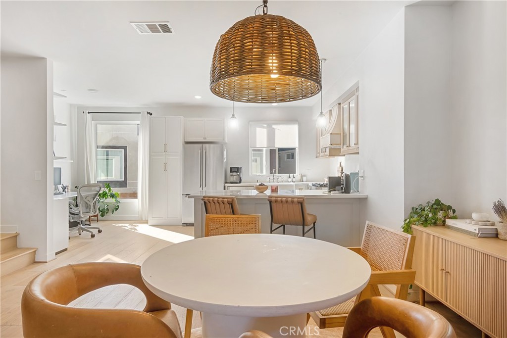 2581 Arvia Street, Unit 3 Los Angeles, CA 90065 - Photo 4 of 52 a dining room with furniture a window and kitchen view