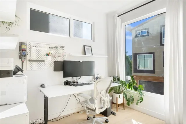 a living room with furniture a flat screen tv and a potted plant