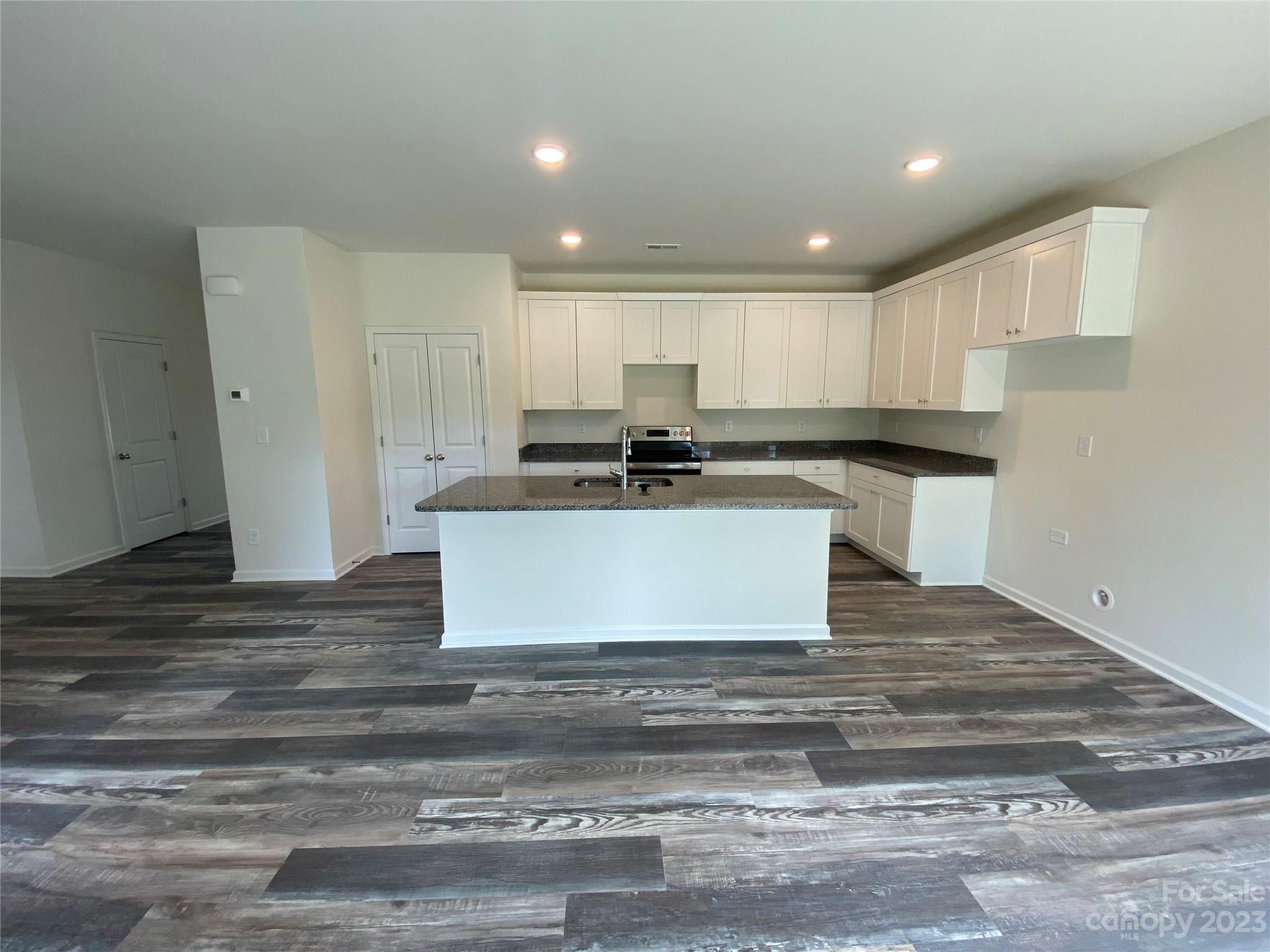 345 Corinth Church Road Mount Ulla, NC 28125 - Photo 3 of 12 a large kitchen with kitchen island a stove a sink and a refrigerator