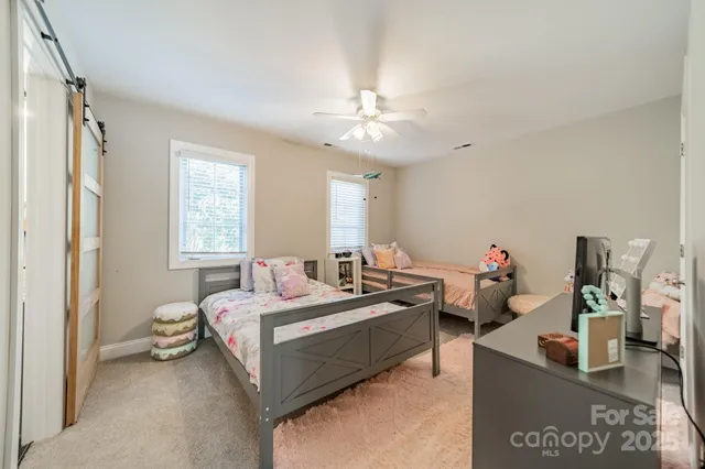 a bedroom with bed and a window