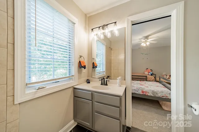 a en suite bathroom with a double vanity sink and a mirror