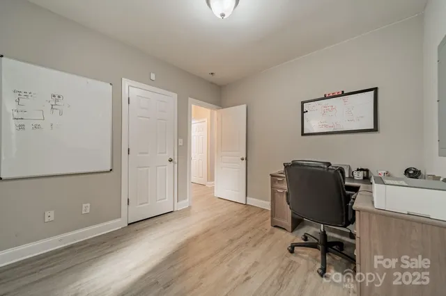 a view of workspace with wooden floor and furniture