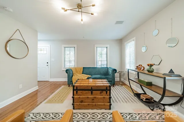 a living room with furniture a rug and a chandelier