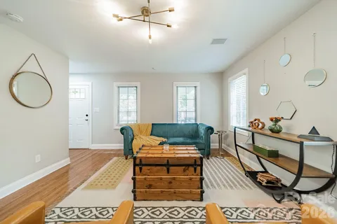 a living room with furniture a rug and a chandelier