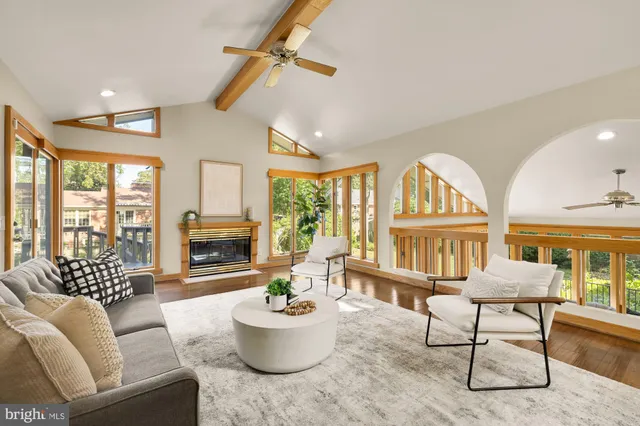 a living room with furniture a fireplace and a large window