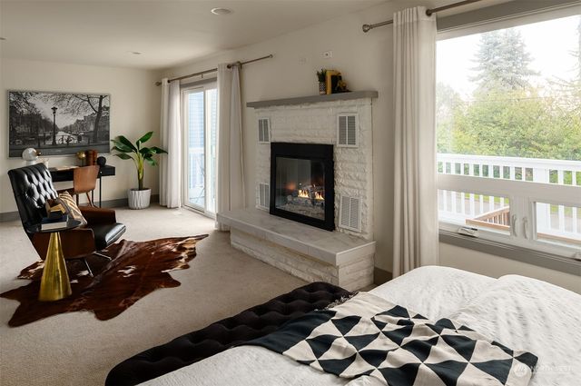 a bedroom with a bed and large windows