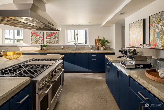 a kitchen with stainless steel appliances granite countertop a sink stove and cabinets