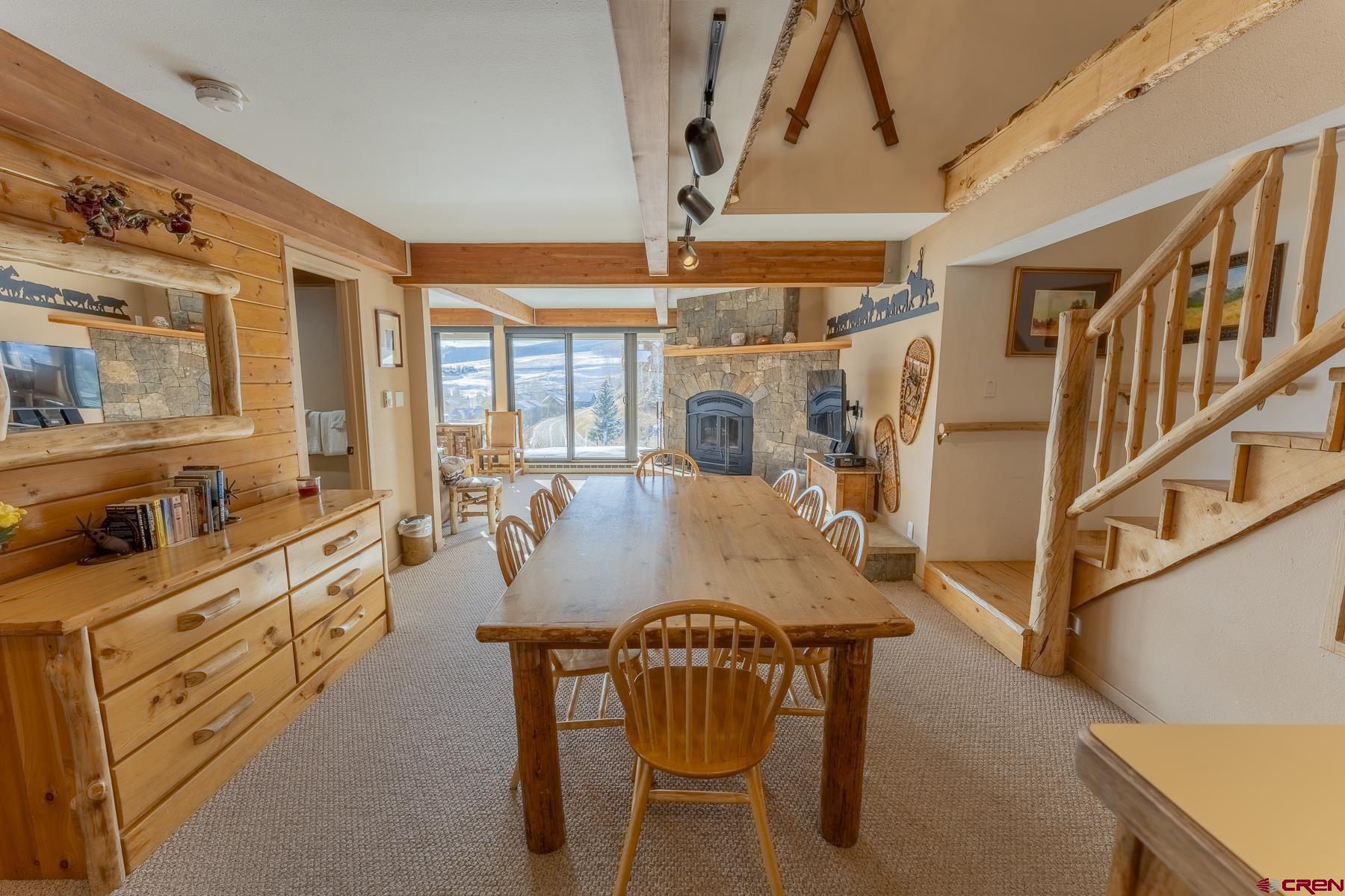 11 Hunter Hill Road, Unit 307 Crested Butte, CO 81225 - Photo 12 of 34 a dining room with furniture and a chandelier