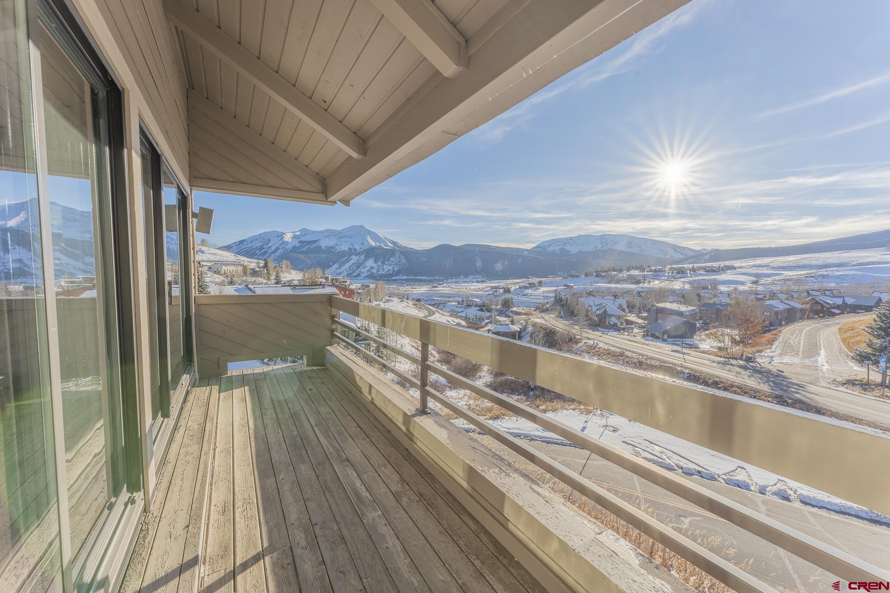 11 Hunter Hill Road, Unit 307 Crested Butte, CO 81225 - Photo 19 of 34 a view of a balcony with floor to ceiling windows with wooden floor