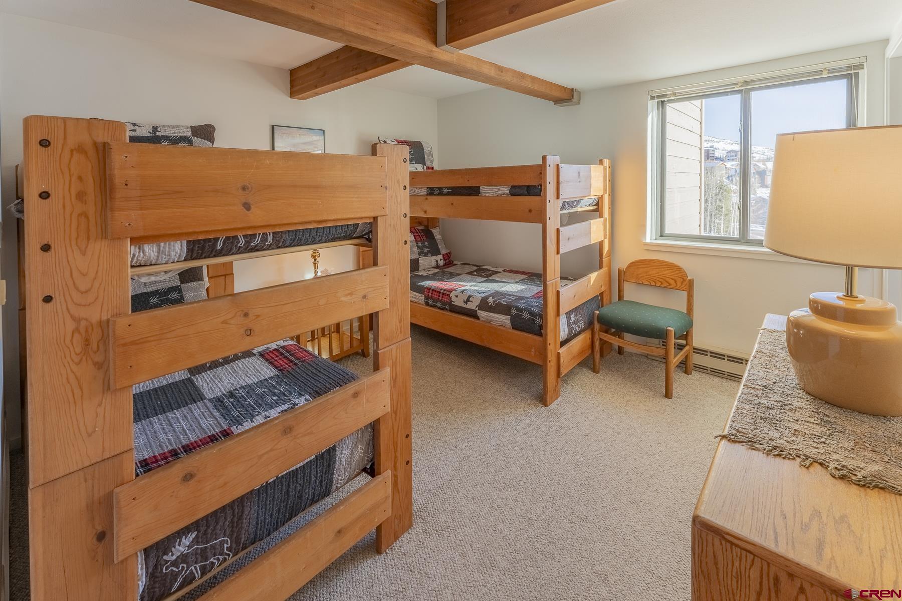 11 Hunter Hill Road, Unit 307 Crested Butte, CO 81225 - Photo 23 of 34 a bedroom with bunk bed and a window