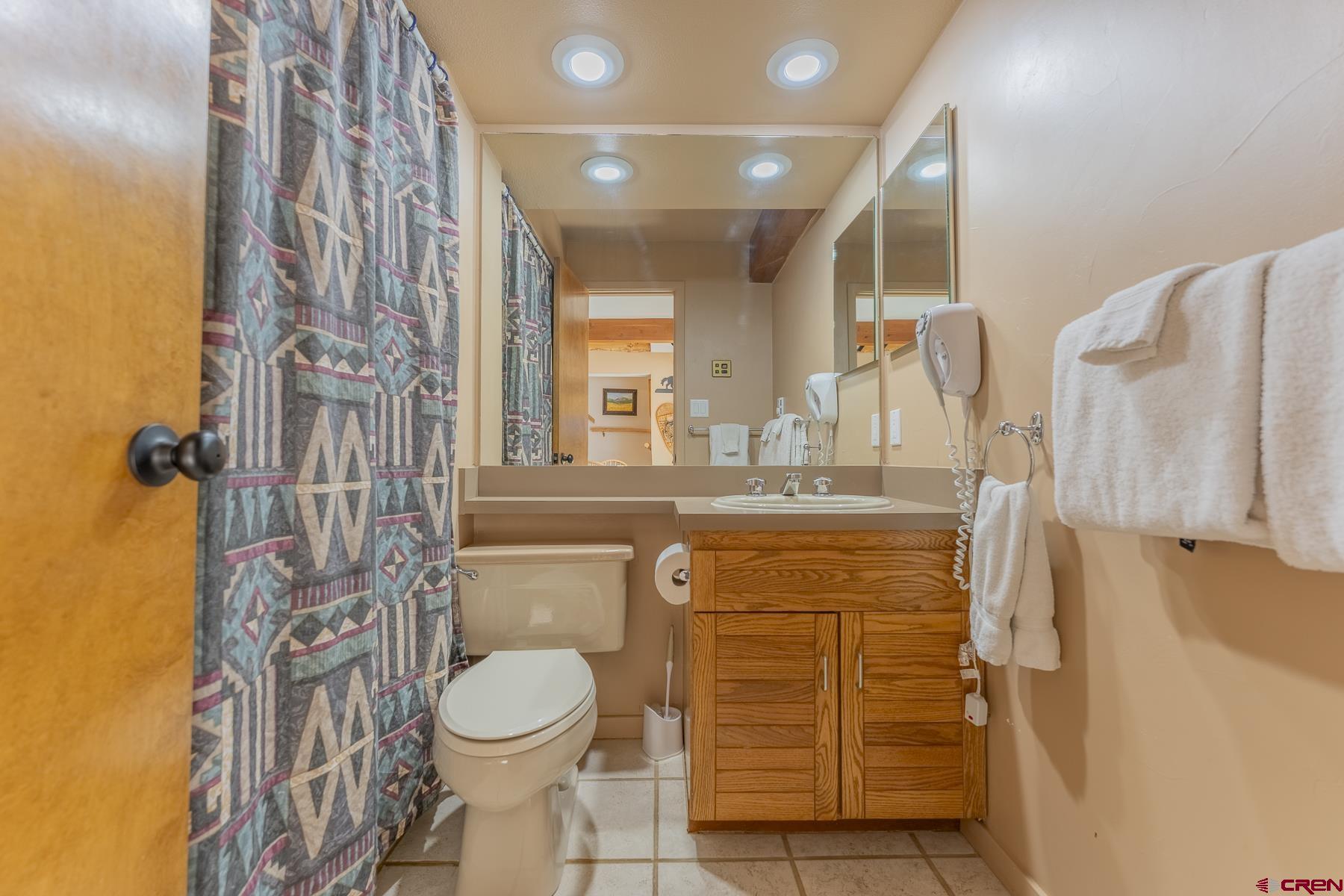 11 Hunter Hill Road, Unit 307 Crested Butte, CO 81225 - Photo 24 of 34 a bathroom with a granite countertop toilet sink and shower