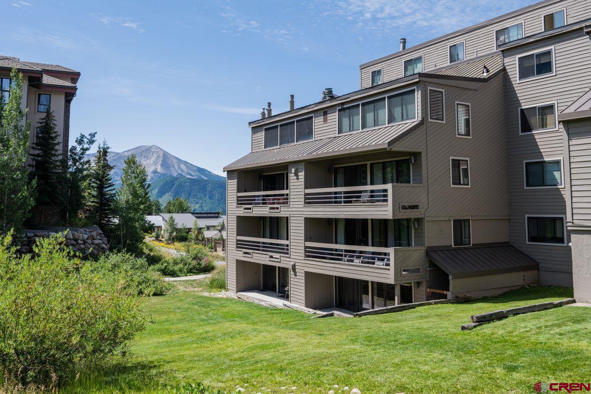 11 Hunter Hill Road, Unit 307 Crested Butte, CO 81225 - Photo 29 of 34 a front view of a house with a yard