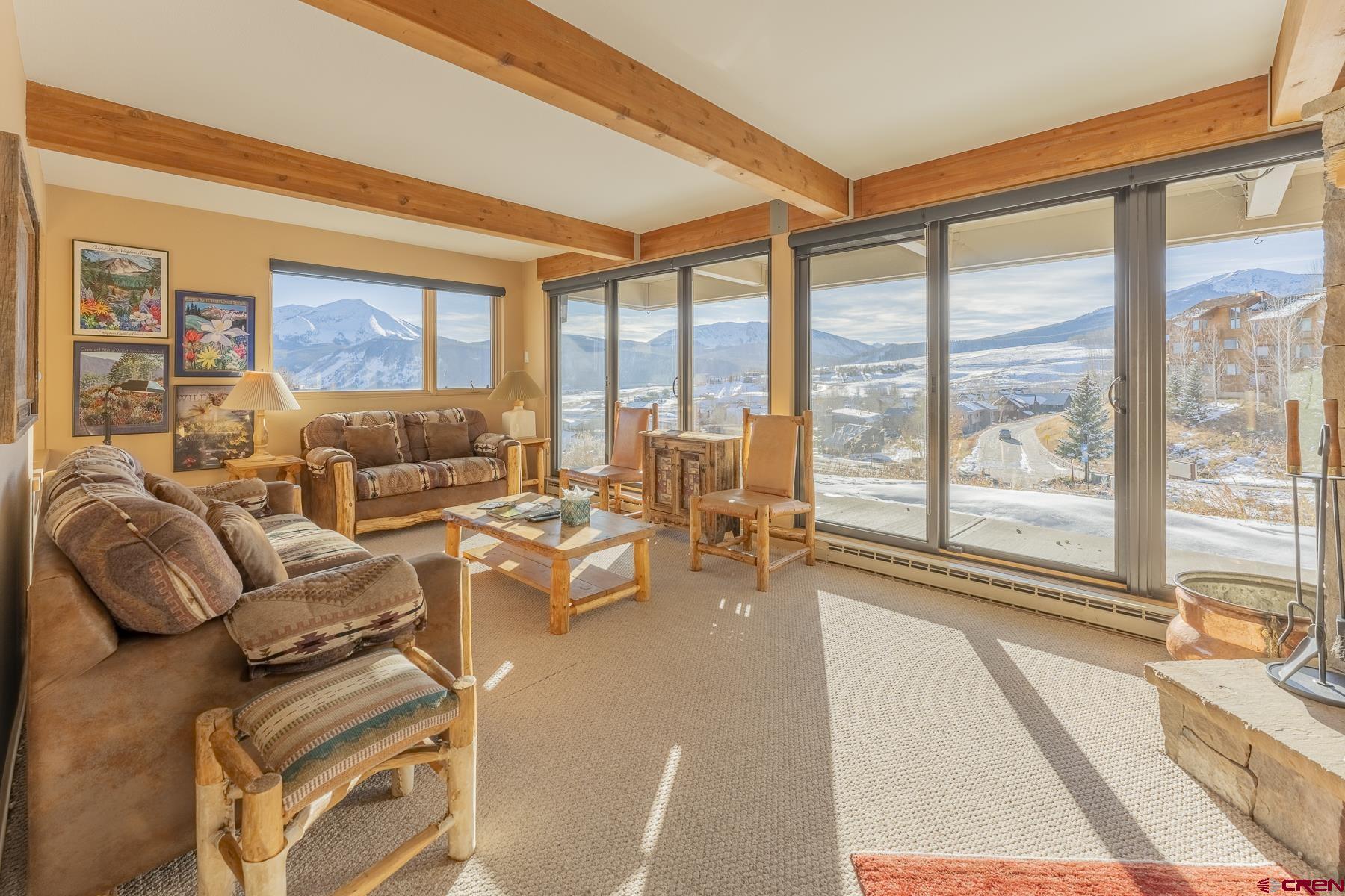 11 Hunter Hill Road, Unit 307 Crested Butte, CO 81225 - Photo 5 of 34 a living room with furniture and floor to ceiling windows