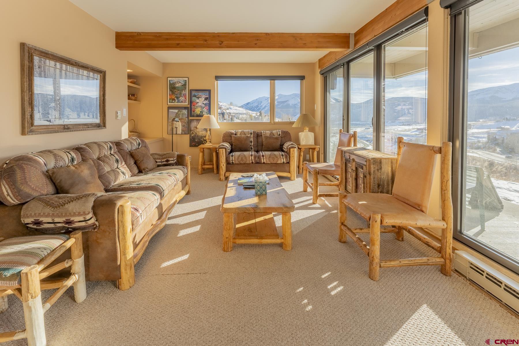 11 Hunter Hill Road, Unit 307 Crested Butte, CO 81225 - Photo 6 of 34 a living room with furniture and a floor to ceiling window