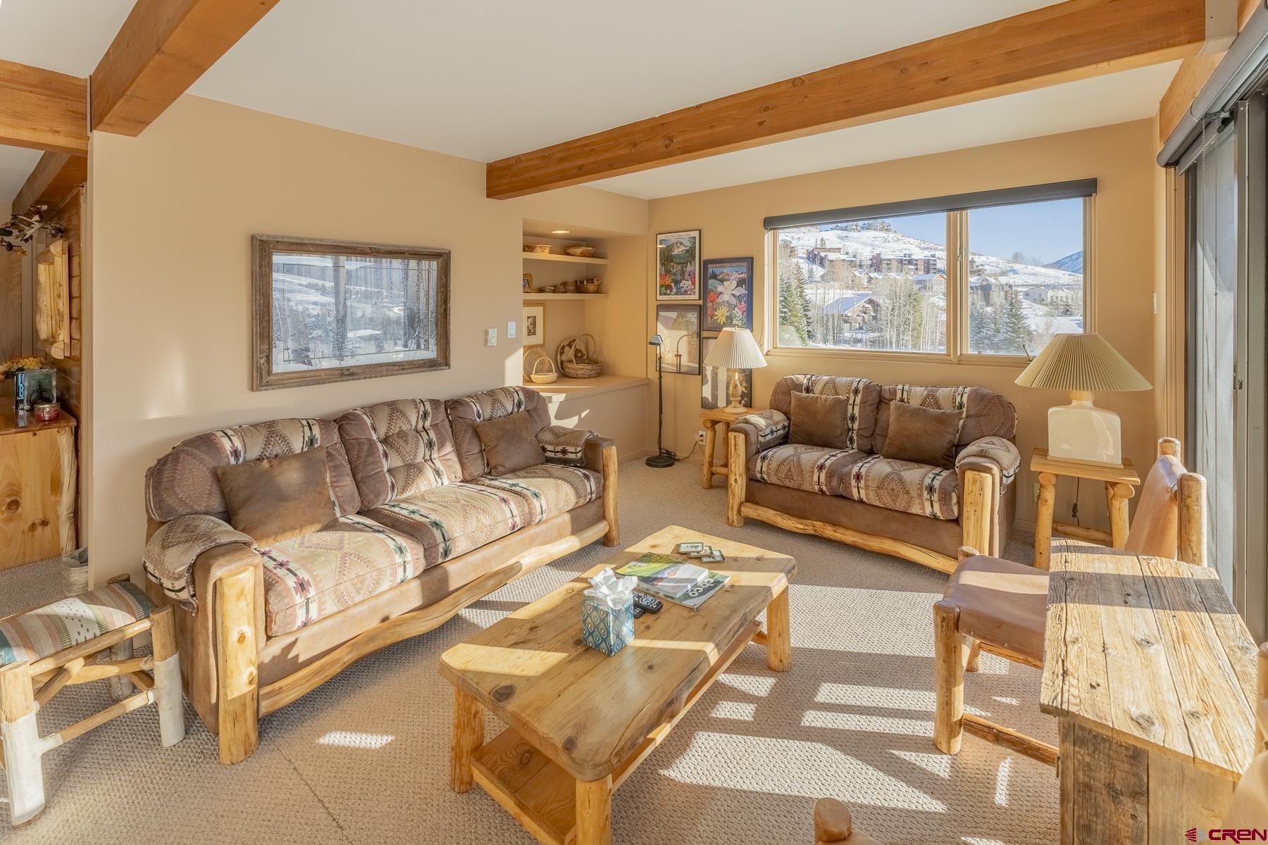11 Hunter Hill Road, Unit 307 Crested Butte, CO 81225 - Photo 7 of 34 a living room with furniture and a large window