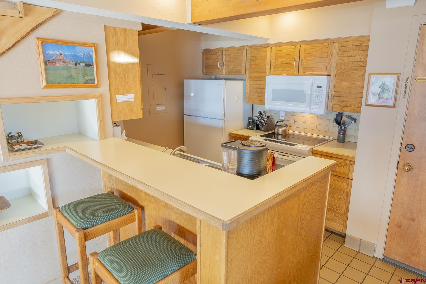 11 Hunter Hill Road, Unit 307 Crested Butte, CO 81225 - Photo 10 of 34 a kitchen that has a sink and a refrigerator