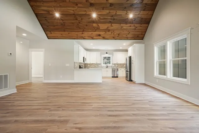 a kitchen with a refrigerator a sink and cabinets