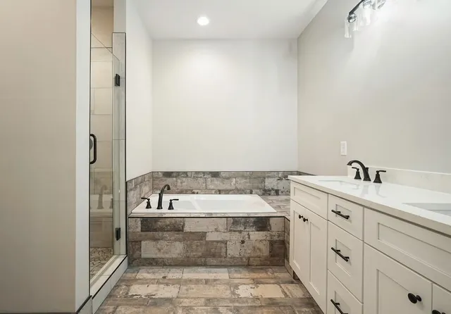 a spacious bathroom with a sink and a bathtub