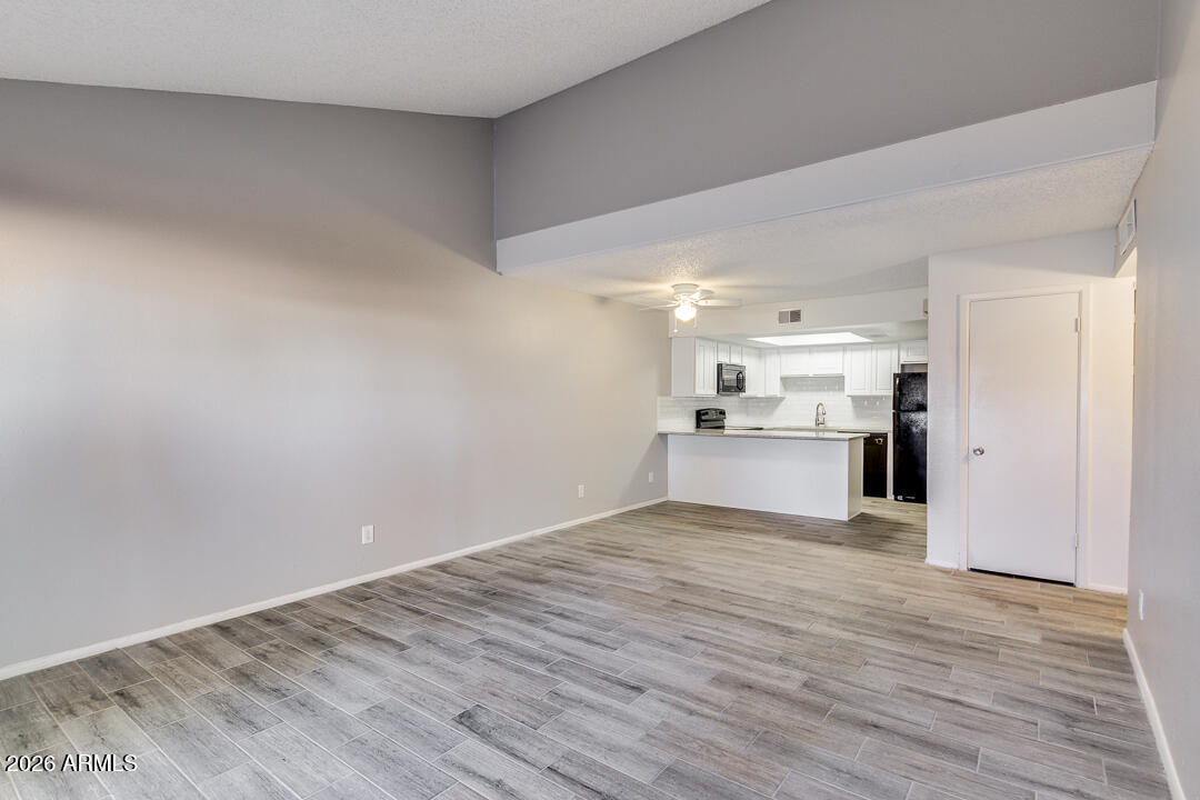 a view of a kitchen with wooden floor