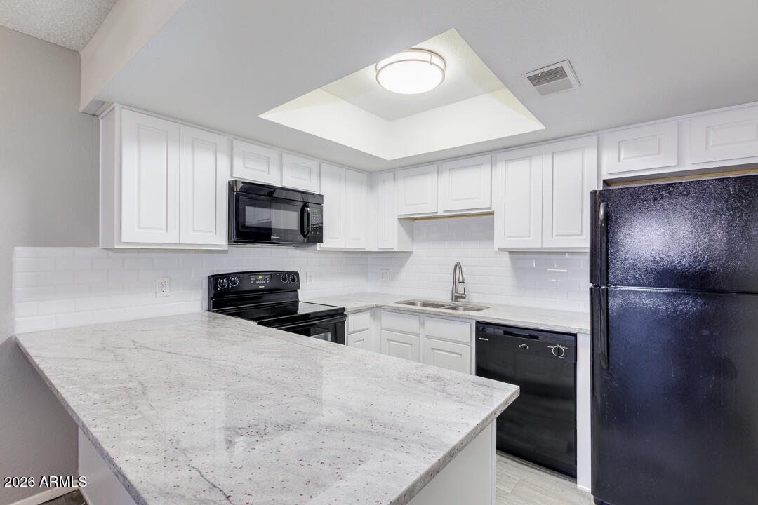 2149 East 10th Street, Unit 3 Tempe, AZ 85281 - Photo 3 of 14 a kitchen with granite countertop a refrigerator stove and microwave