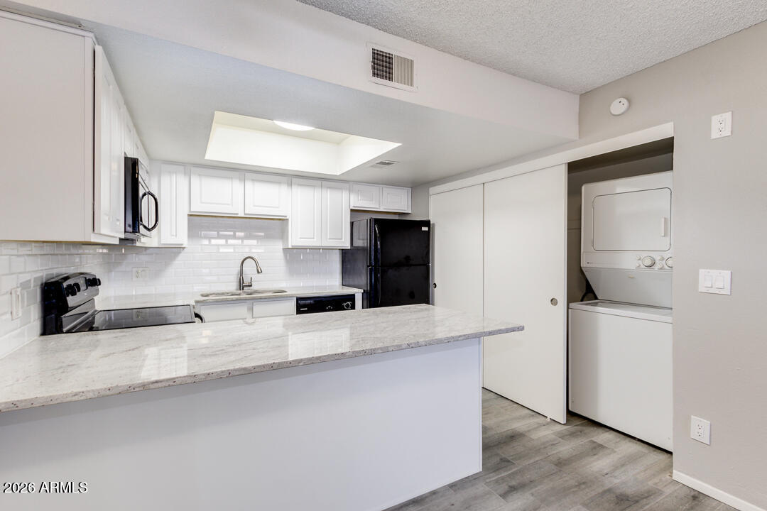2149 East 10th Street, Unit 3 Tempe, AZ 85281 - Photo 5 of 14 a kitchen with stainless steel appliances granite countertop a sink and a refrigerator