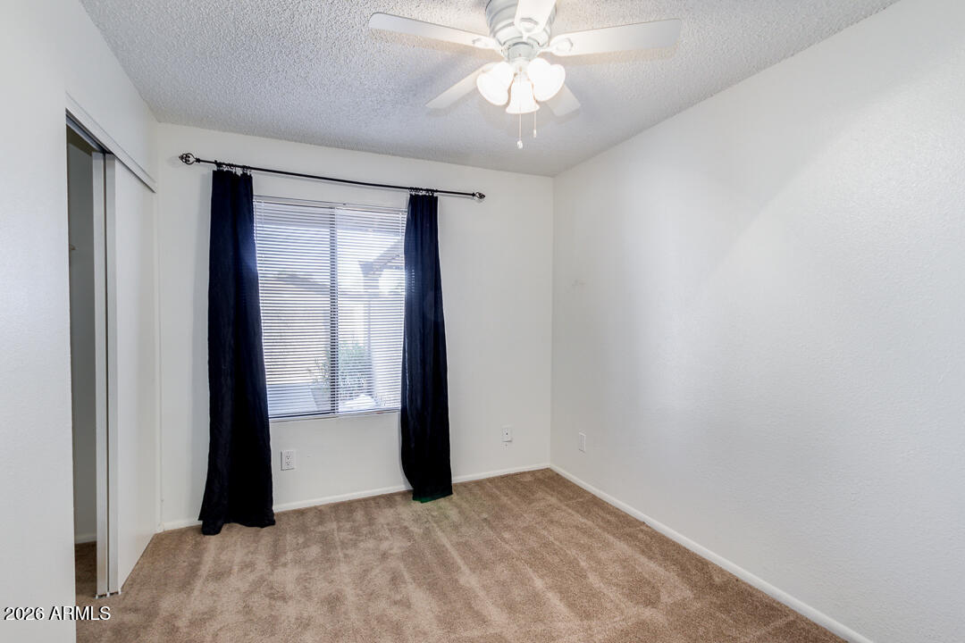 2149 East 10th Street, Unit 3 Tempe, AZ 85281 - Photo 9 of 14 an empty room with windows and closet