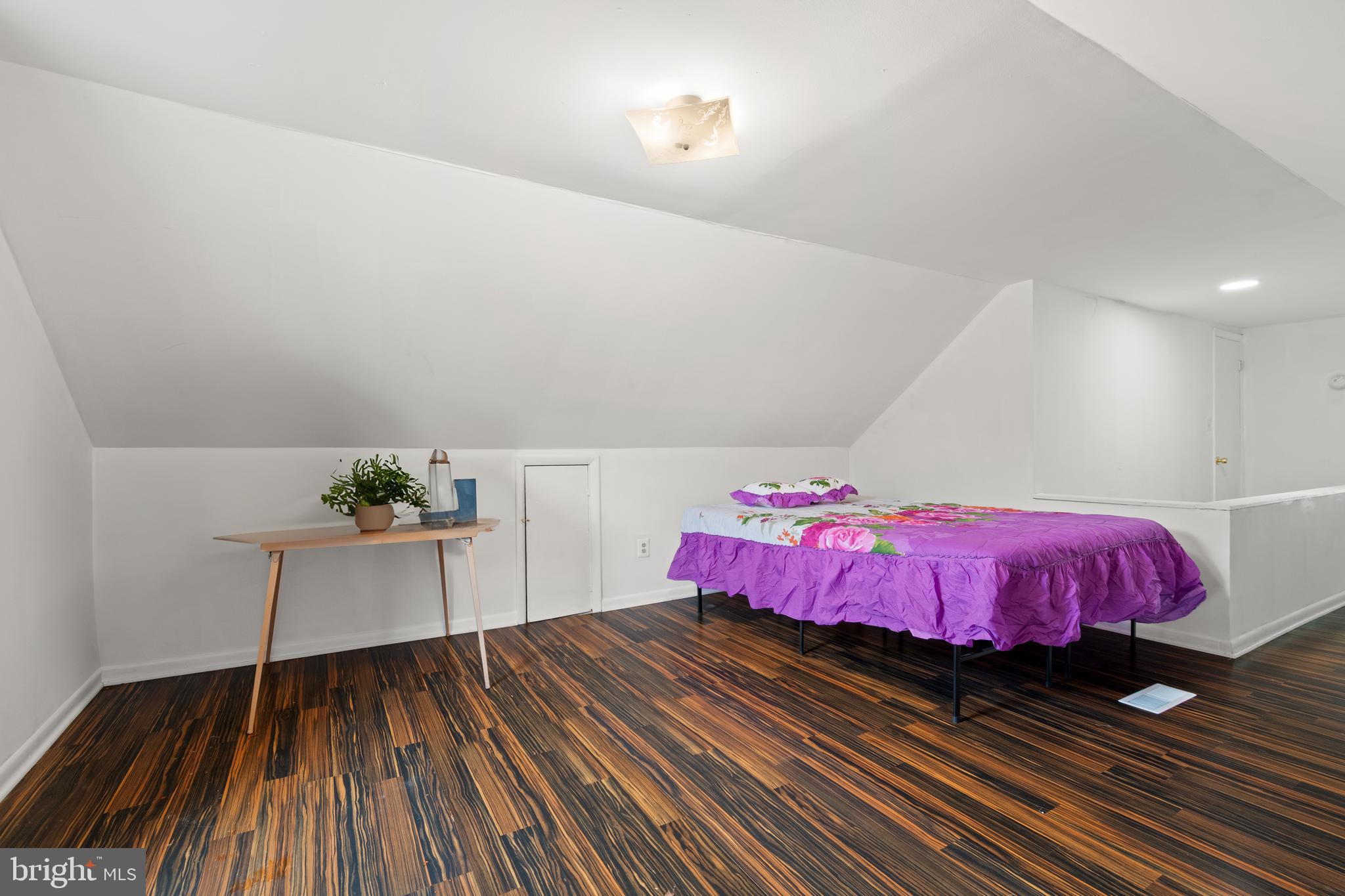 4410 Allies Road Suitland, MD 20746 - Photo 20 of 30 a bedroom with a bed and wooden floor