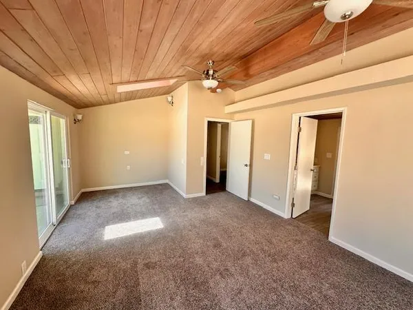 a view of empty room with ceiling fan