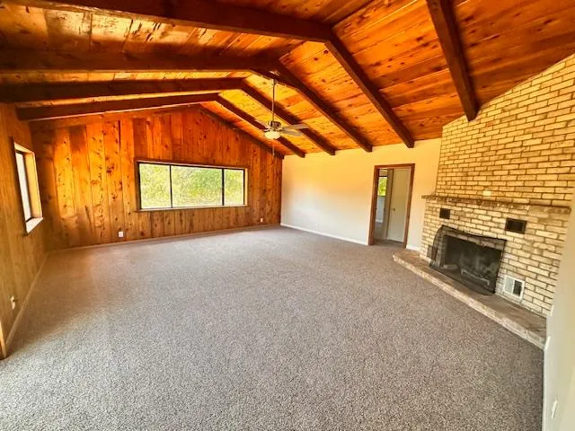 a view of empty room with a fireplace