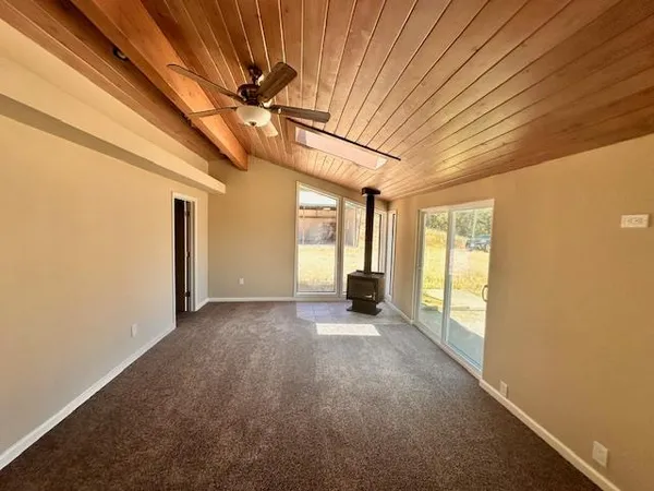 a view of a livingroom with a ceiling fan and window