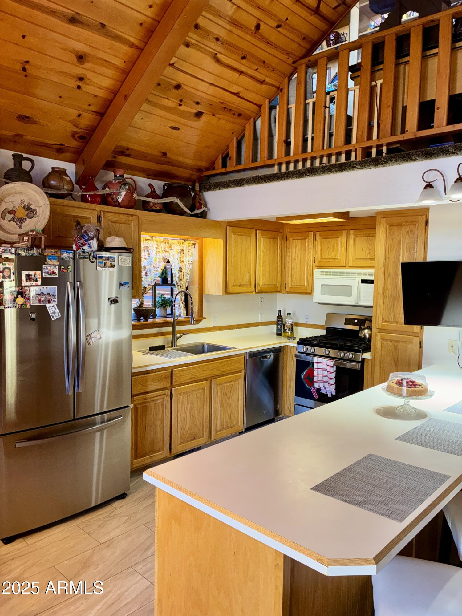 2761 Apollo Circle Overgaard, AZ 85933 - Photo 2 of 52 a kitchen with stainless steel appliances granite countertop a sink a stove and a refrigerator