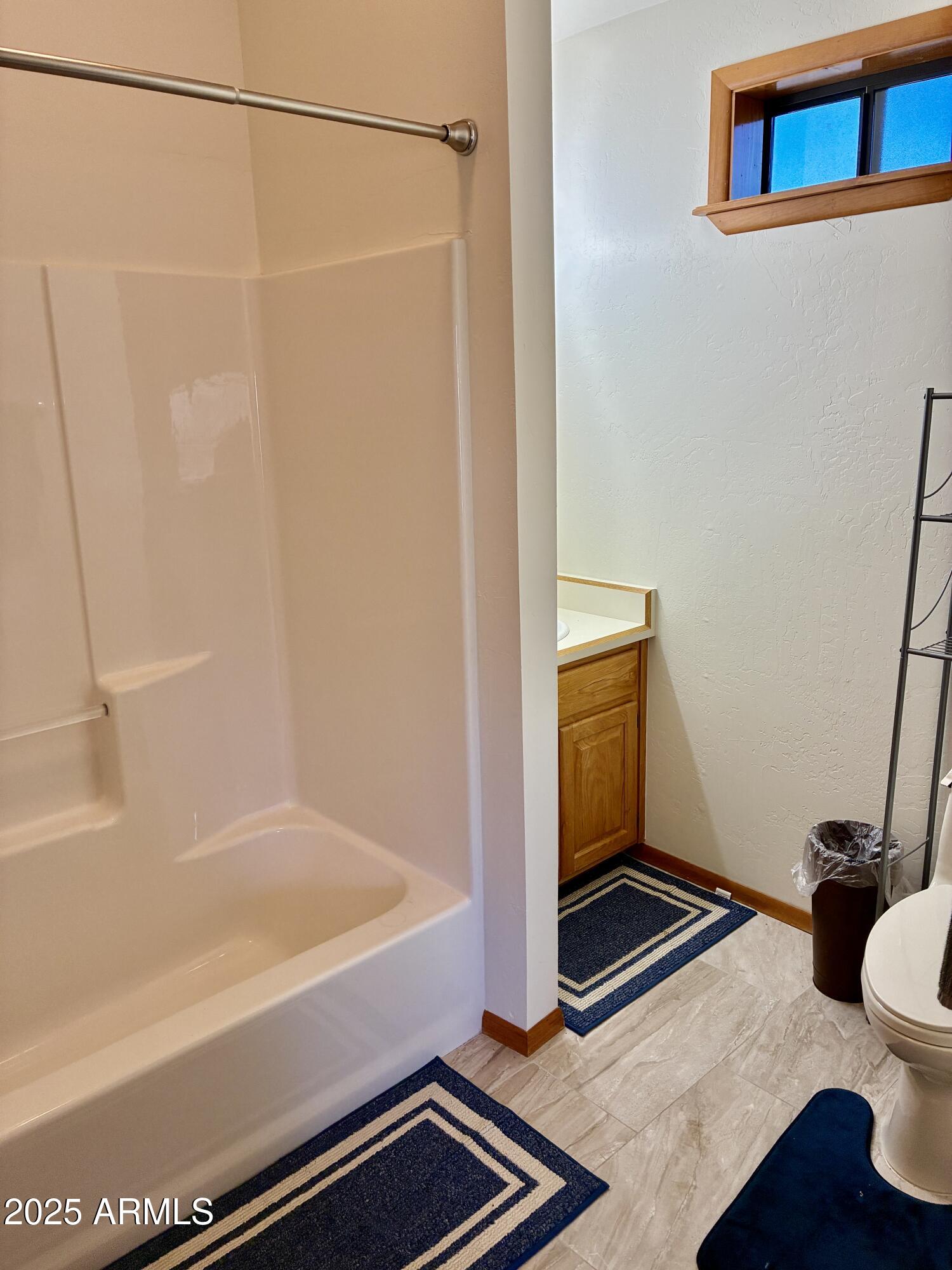 2761 Apollo Circle Overgaard, AZ 85933 - Photo 38 of 52 a bathroom with a bathtub and a shower