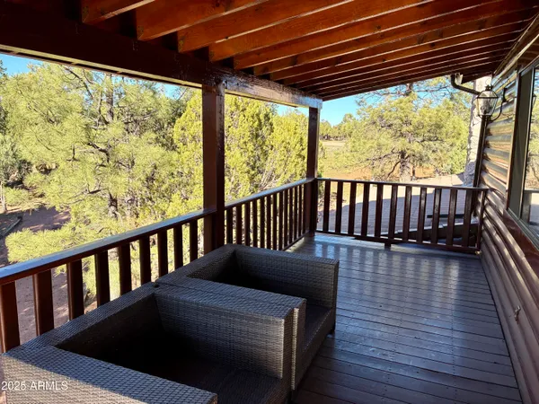a balcony with wooden floor in outdoor space