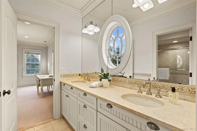 a bathroom with double vanity sinks and a mirror