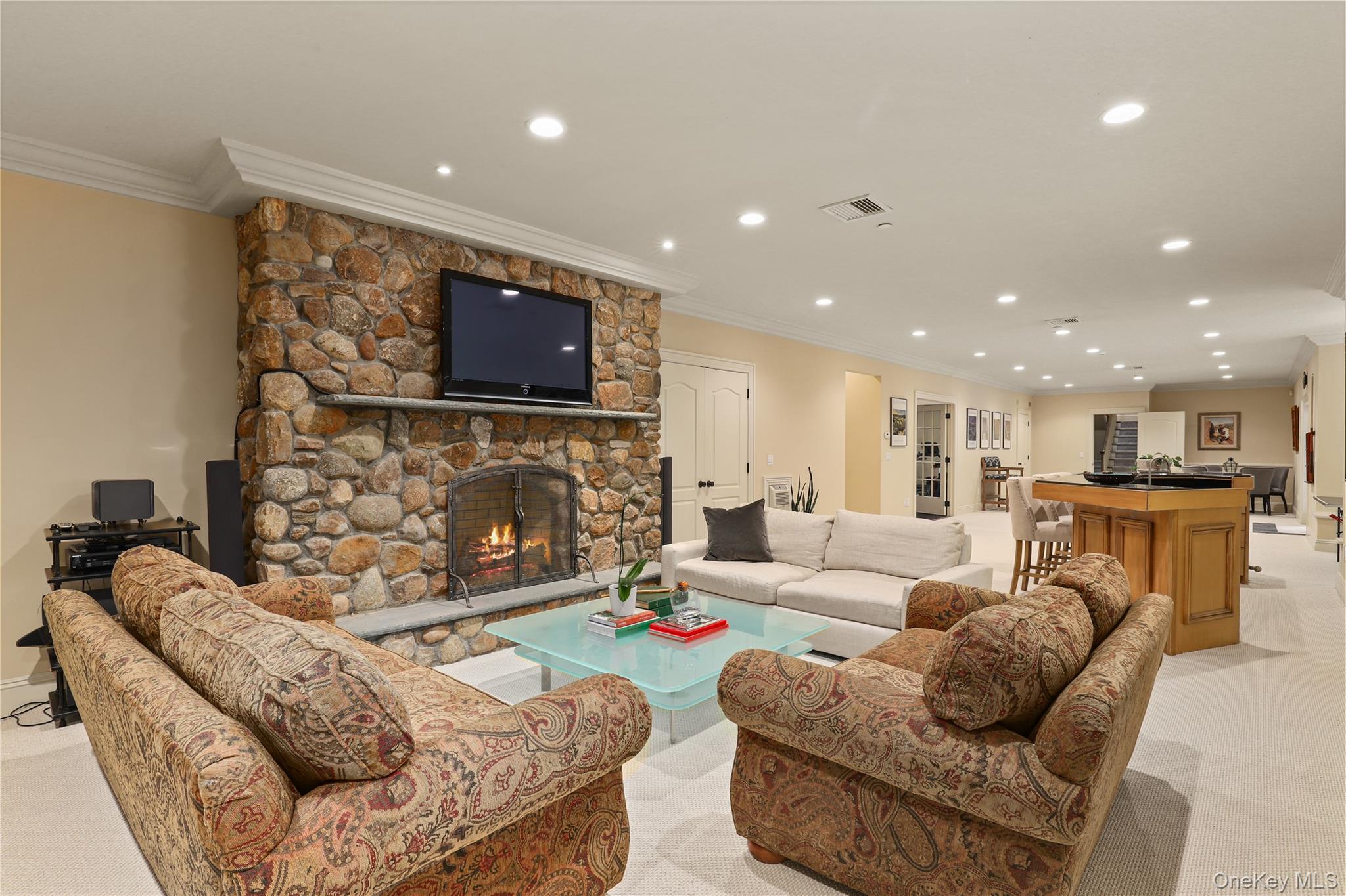 3 Brook View Lane Rye, NY 10580 - Photo 40 of 49 a living room with furniture a flat screen tv and a fireplace