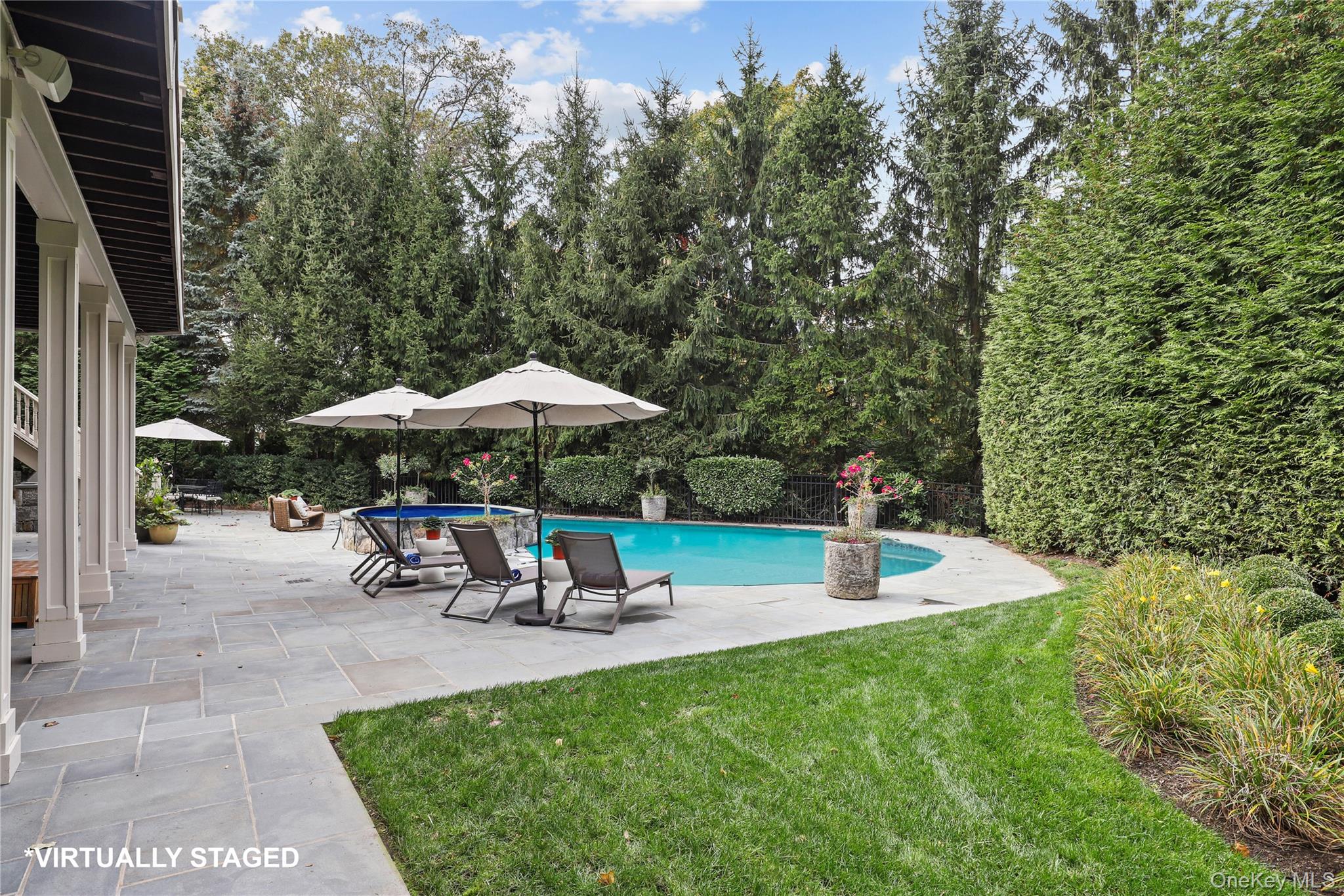 3 Brook View Lane Rye, NY 10580 - Photo 45 of 49 a view of a table and chairs under an umbrella