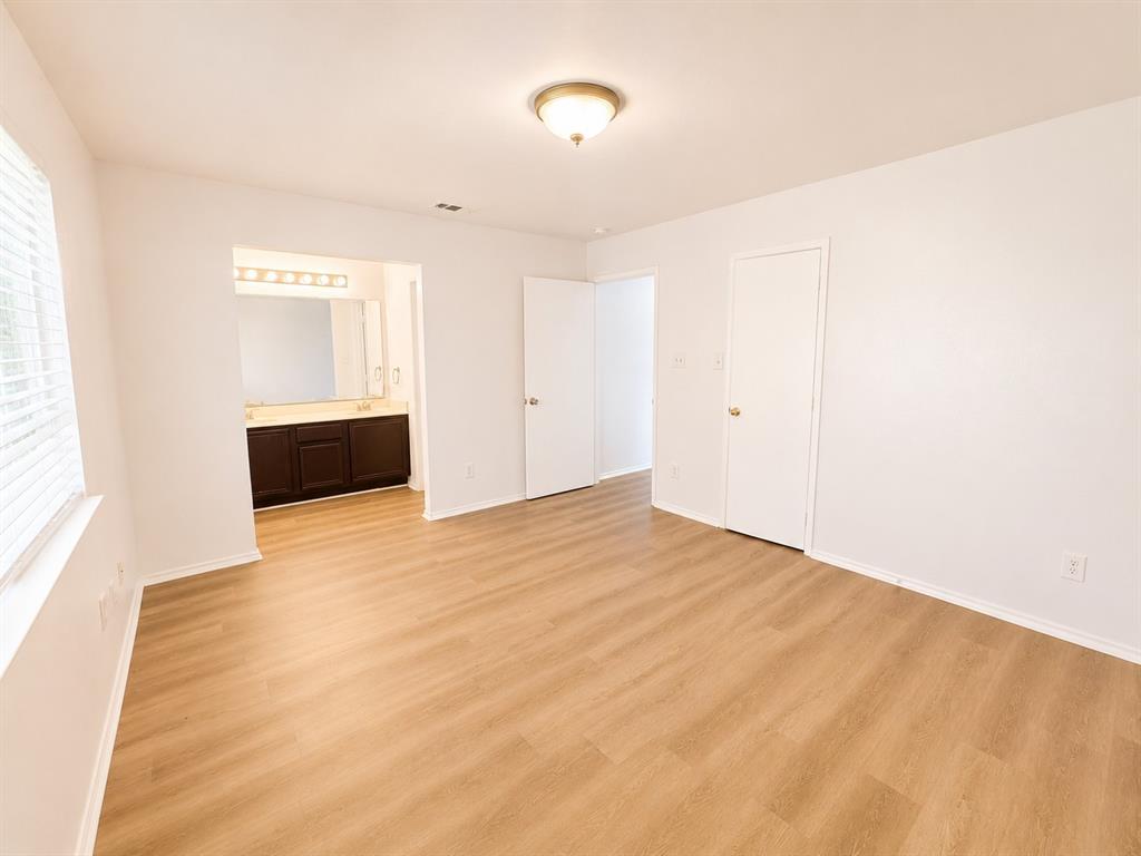 515 Haymarket Road Dallas, TX 75217 - Photo 5 of 15 Room featuring wood-finish flooring, white walls, and a ceiling-mounted light fixture