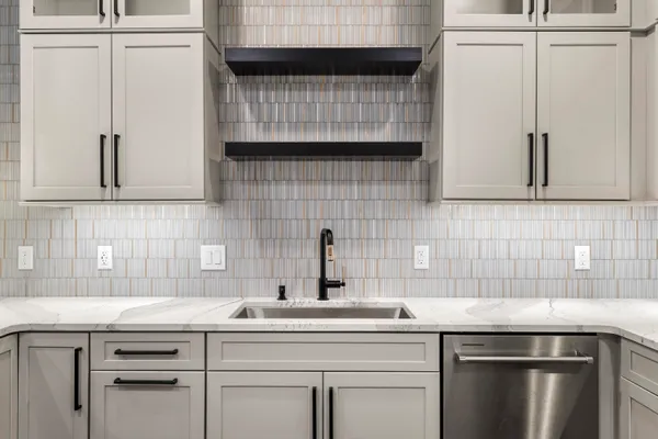 a kitchen with a sink cabinets and stainless steel appliances